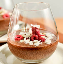 image of chocolate chia seed pudding garnished with freeze-dried raspberries and coconut slivers