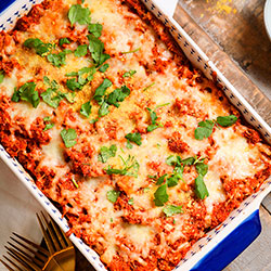 image of a dish of quinoa pizza casserole garnished with fresh parsley