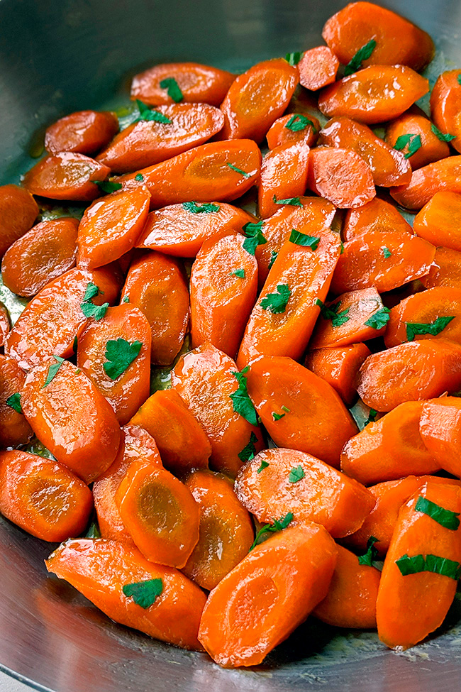 These orange glazed carrots are the perfect side. Bright and sunny fresh carrots, lightly glazed with orange juice, honey and a little butter to make a delicious and healthy side dish! With paleo and dairy-free options.