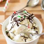image of scoops of homemade candy cane chocolate chunk ice cream with chocolate drizzled on top