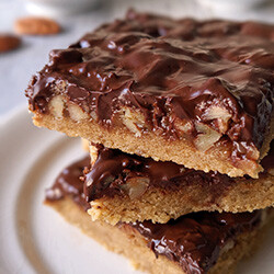 closeup image of turtle cookie bars stacked on a plate