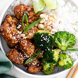air fryer sesame chicken in bowl with rice and broccoli