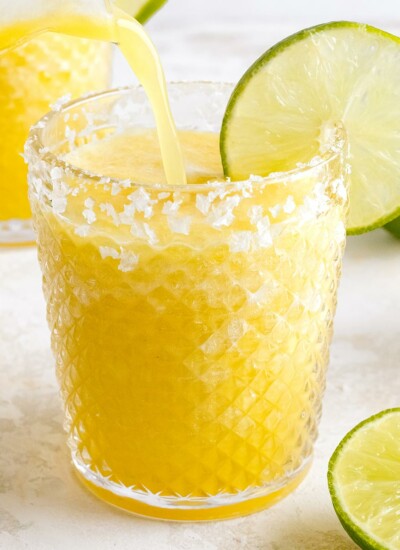 pineapple margarita being poured in glass