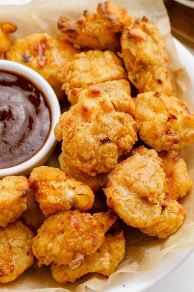 homemade popcorn chicken on plate with dipping sauce