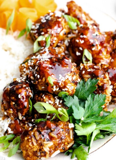 air fryer teriyaki chicken on plate with green onions and rice