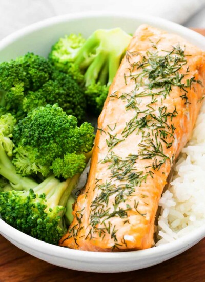 close-up of a bowl with filet of air fryer salmon and broccoli and rice