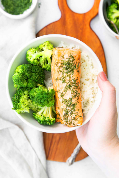 bowl with filet of air fryer salmon and broccoli and rice