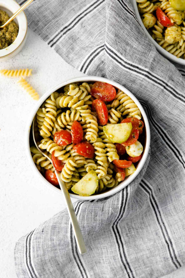 bowl of summer pesto pasta salad on a grey napkin