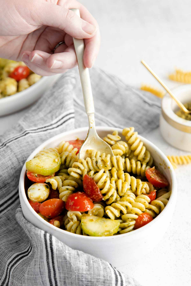 spoon digging into bowl of pasta salad