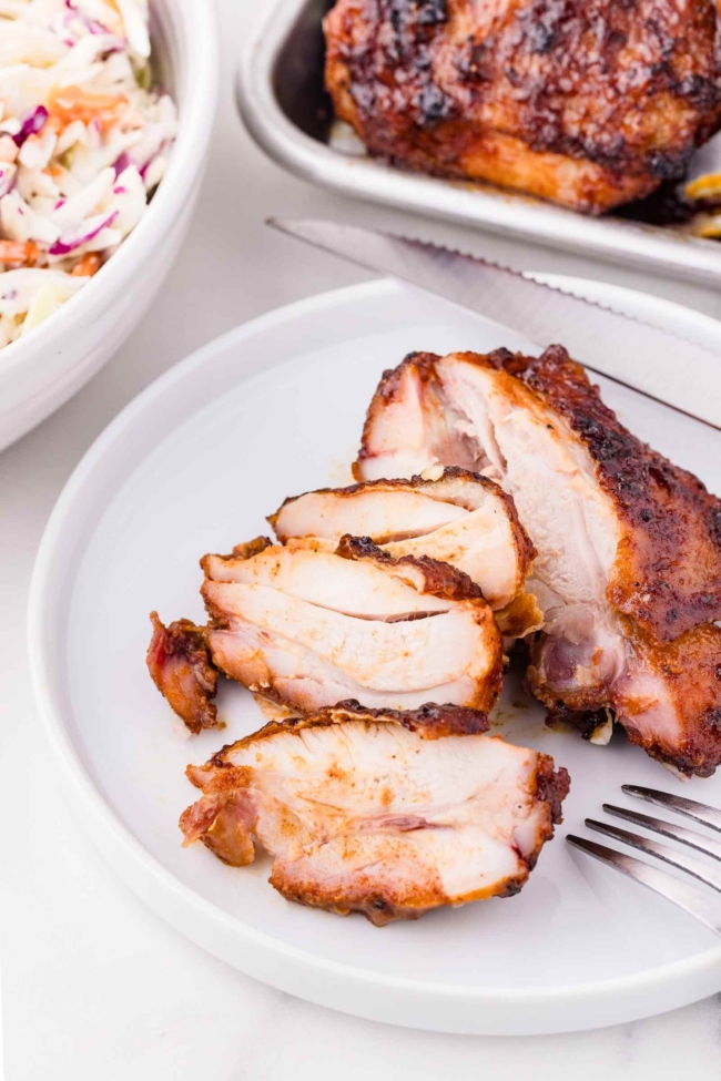 barbequed chicken thighs on a white