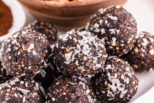 plate filled with chocolate coconut nut balls