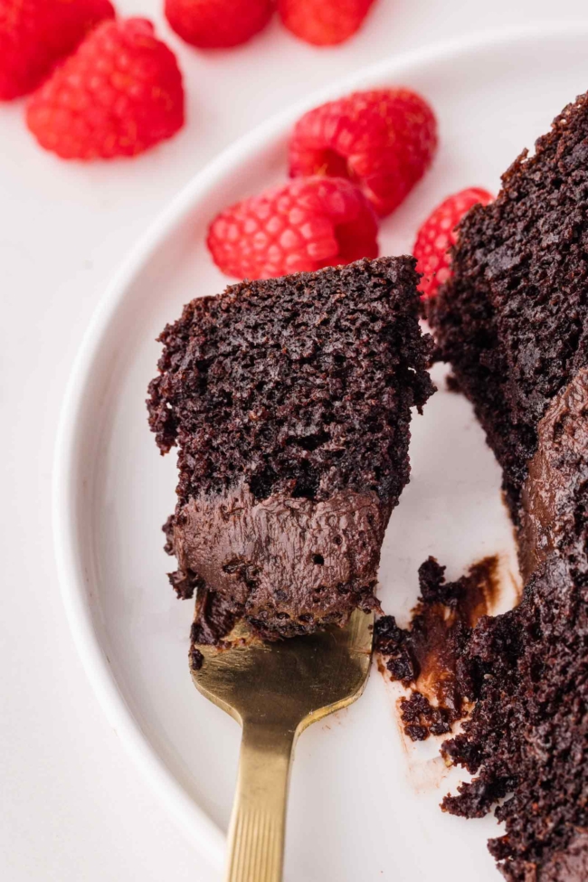 fork picking up a bite of dark cocoa cake