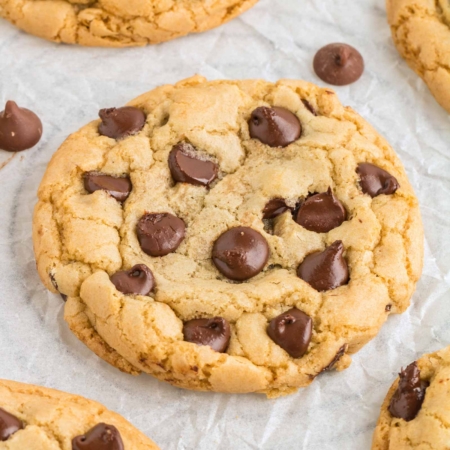 Close-up photo of a perfect chocolate chip cookie made without butter that is loaded with chocolate chips.