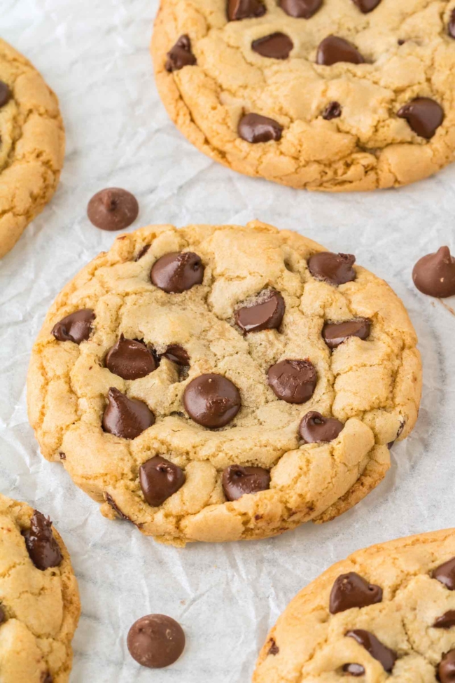 close-up of on butter chocolate chip cookies on white parchment paper