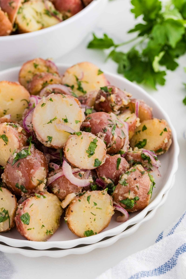 white bowl filled with no mayo potato salad with more in background
