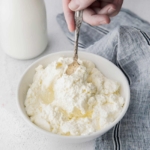 spoon digging into a bowl of ricotta cheese