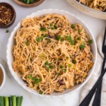 honey garlic noodles in a white bowl on a white table