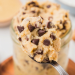 spoon digging into a jar of cottage cheese cookie dough