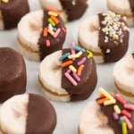close-up of peanut butter bananas on white parchment paper